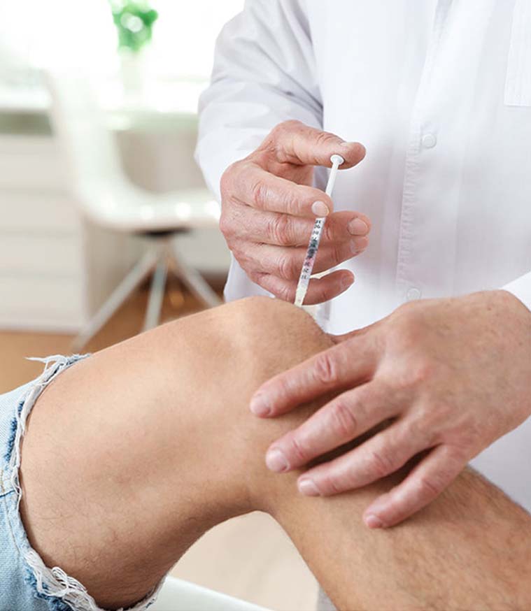 Doctor performing Advanced Joint Pain Relief injection on patient's sore joint